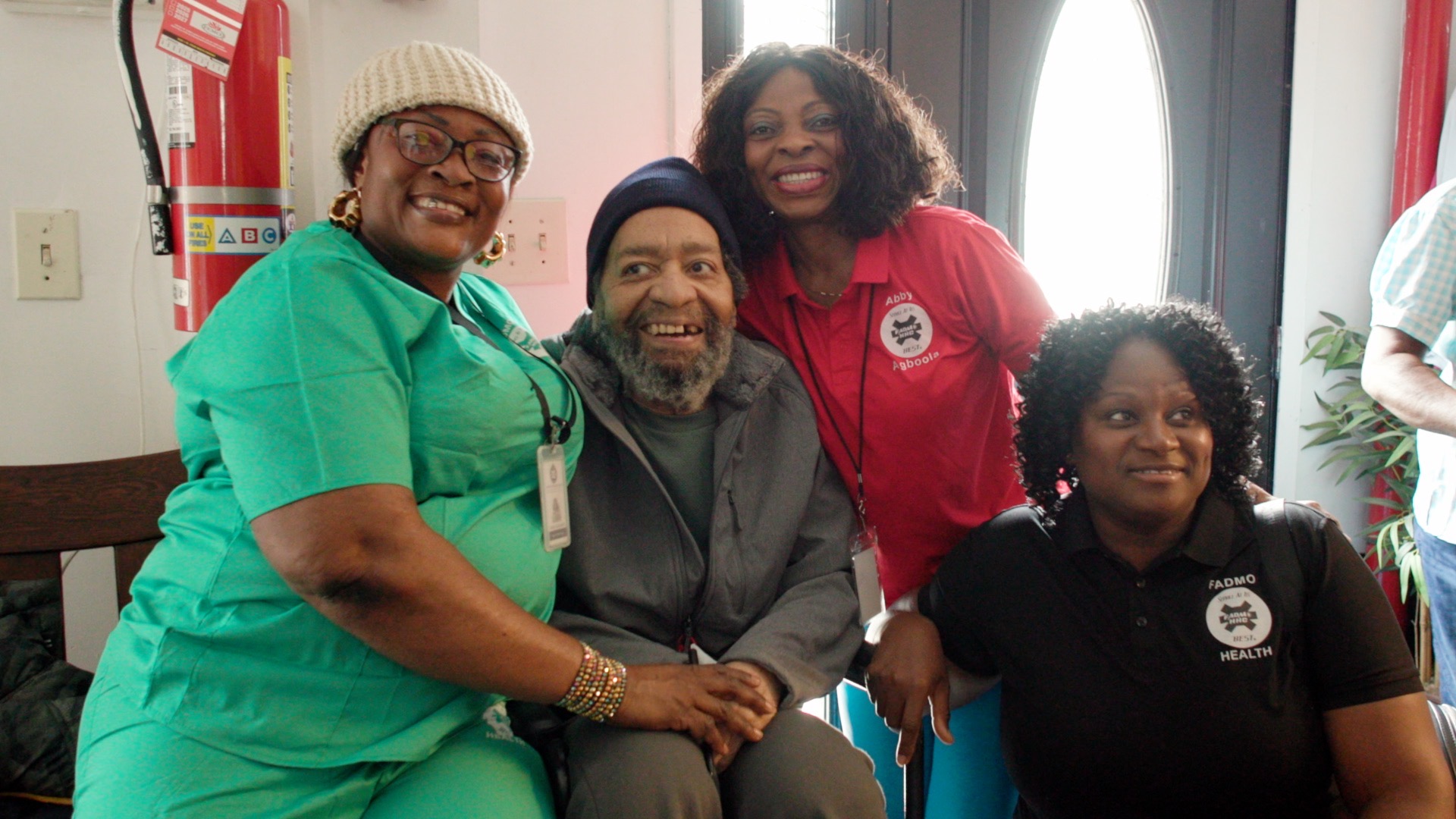 Ms. Abby and FADMO team smiling with a happy client