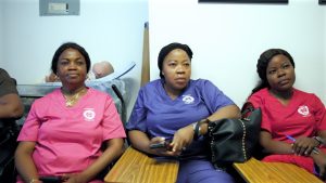 FADMO caregivers who provide home care in Morris Park Bronx, seated together at the agency office